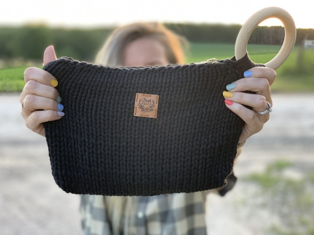 Modern knit bag with a wood bangle.