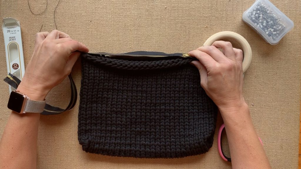 Attaching a zipper to a knit bag.