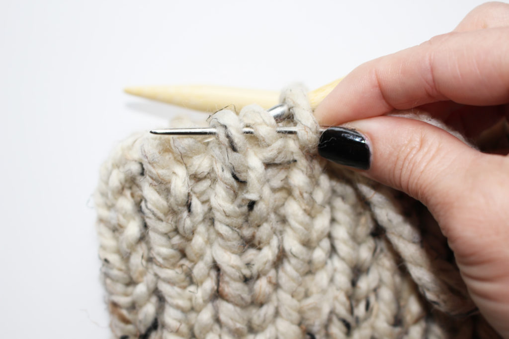 How to cinch the top of a knit hat closed.