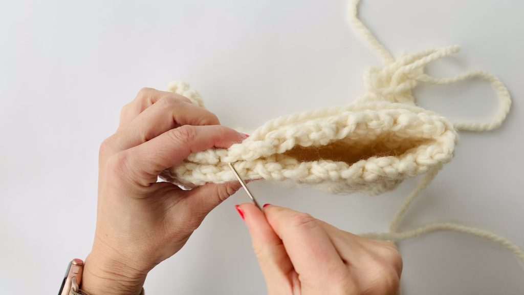 Seaming a crochet bag.