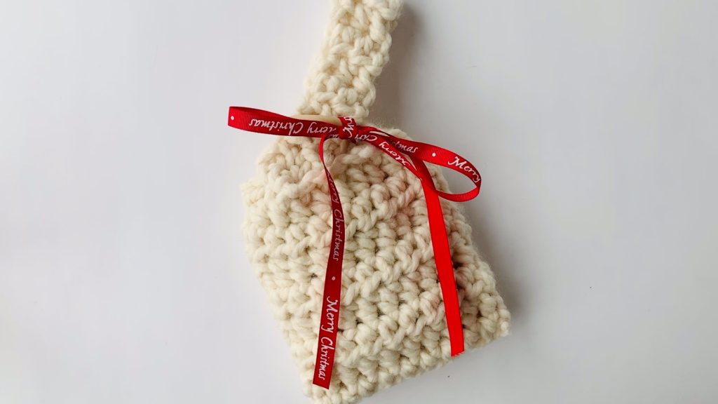 Add ribbon to crochet gift bag.
